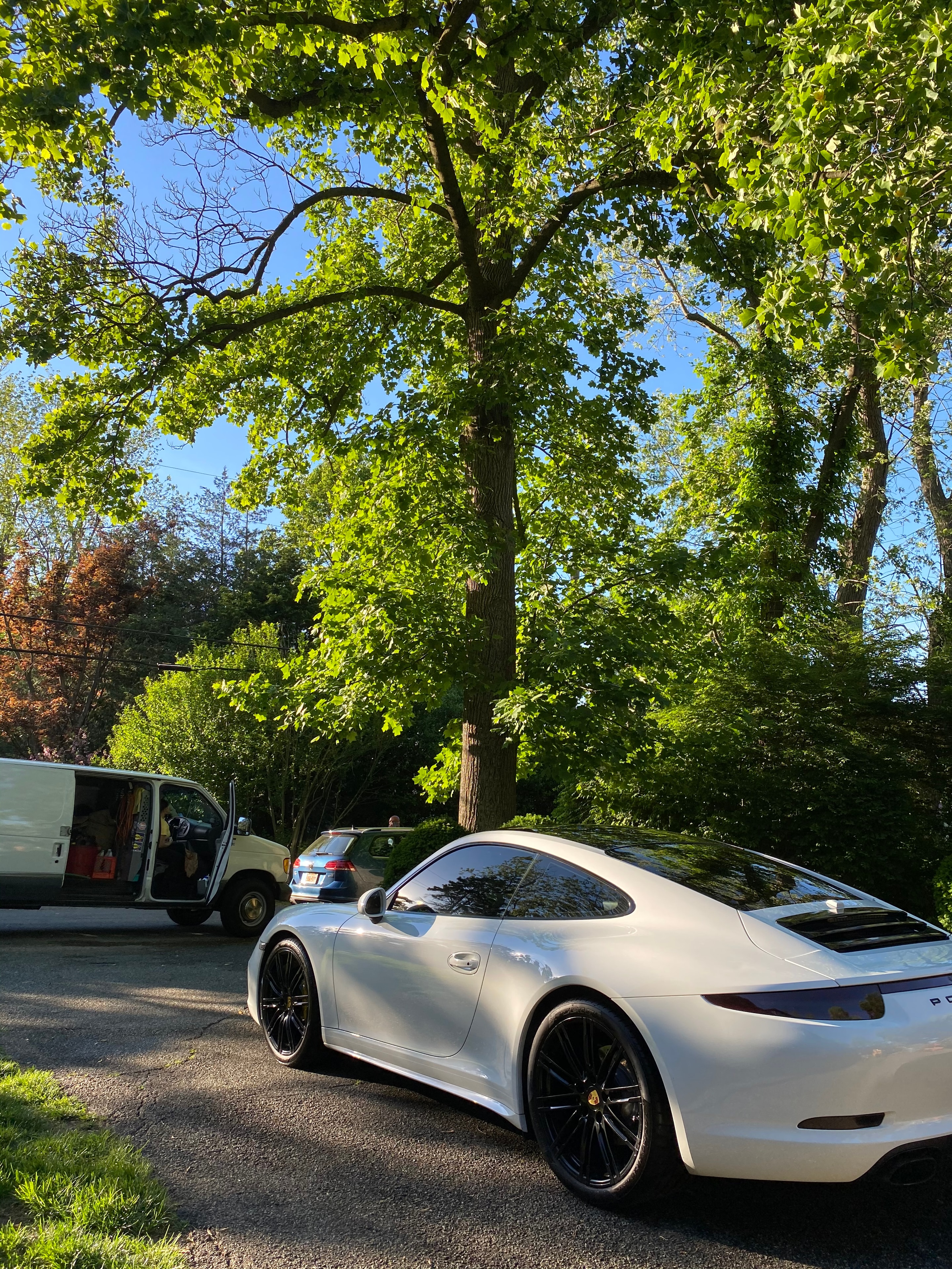 White Porsche detailed on a tree-lined Westchester street