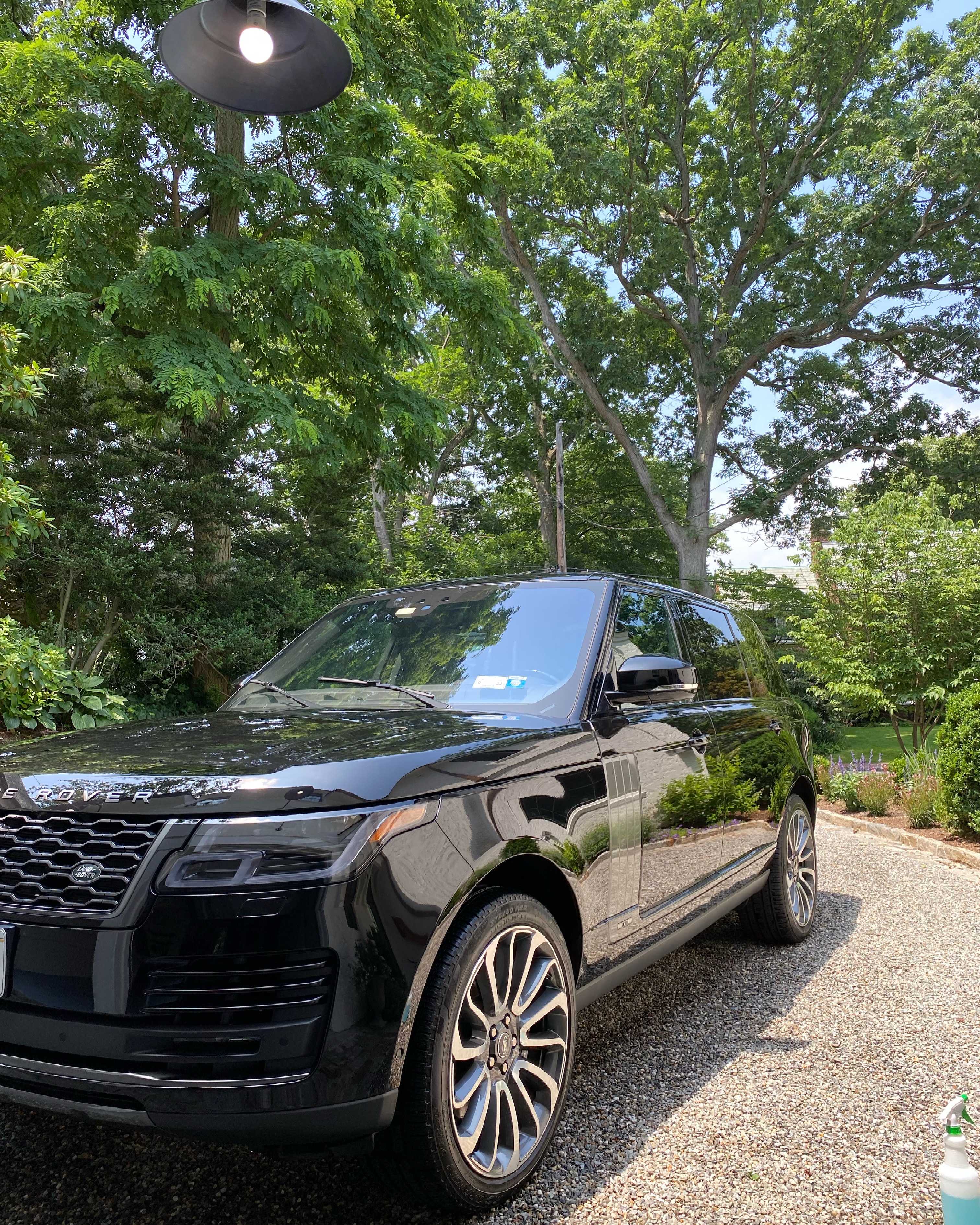 Black Range Rover freshly detailed on a gravel driveway